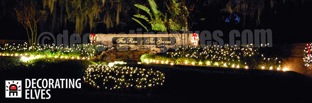 Commercial-Entrance-with-Wreaths-on-Sign,-Staked-Lighting-around-beds-and-minis-through-out-hedges-www.decoratingelves.com