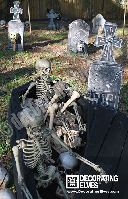 Halloween Skeletons in a Display with Coffin, Graveyard, Tombstone Décor, Skulls,