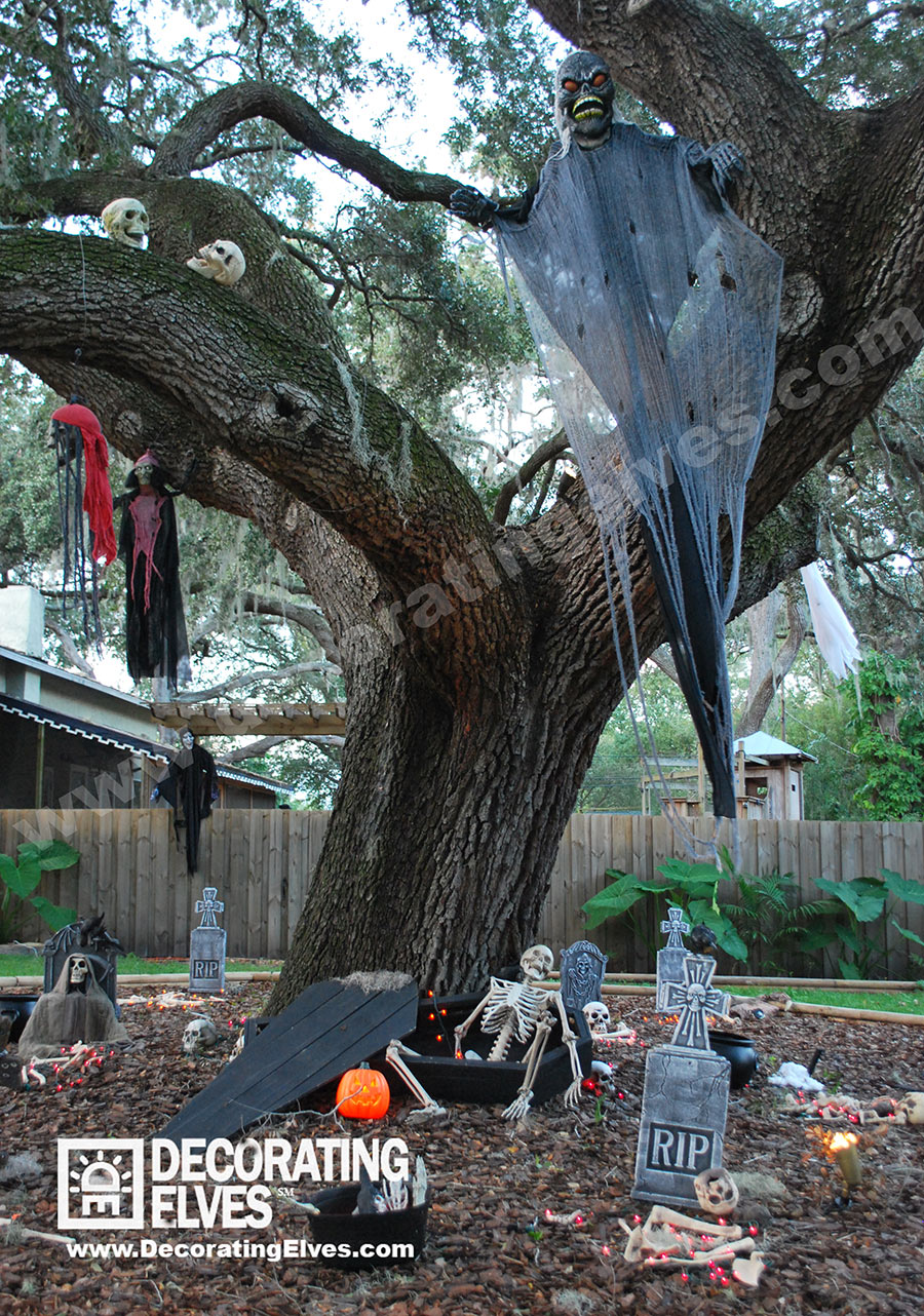Halloween Décor Display with Hanging Ghosts and Monsters over Coffin with Tombstones & Skeletons