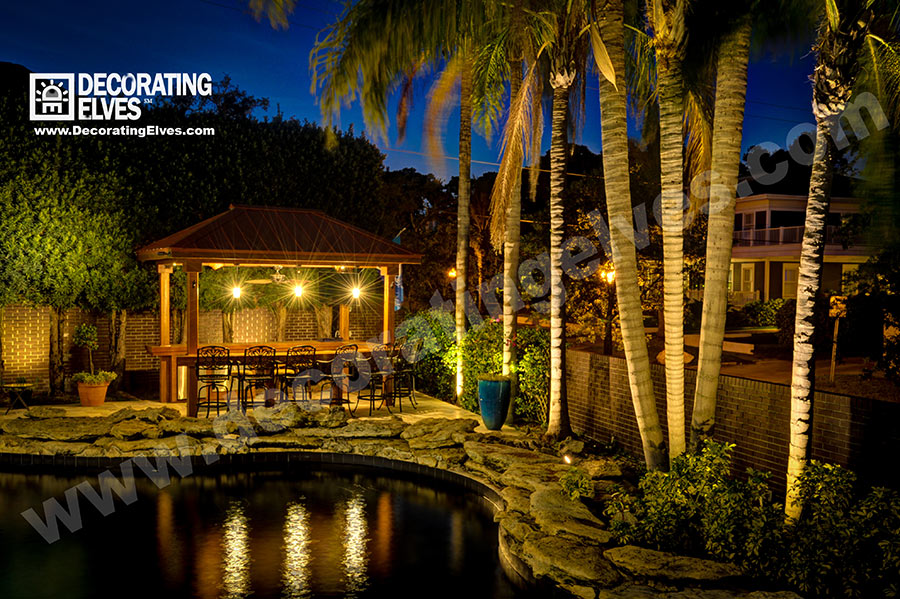 Outdoor-Cabana-Bar-Lighting--with-Palm-Lighting-and-Pool-Reflection-www.decoratingelves.com