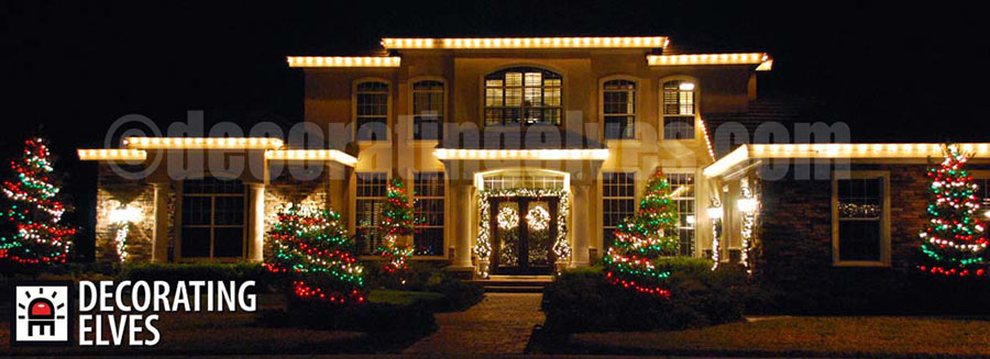 Outlined-Roofline-Red-and-Green-wrapped-bushes-and-trees-Wreaths-Garland-Wrapped-Entrance-www.decoratingelves.com