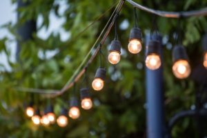 52376816 - hanging decorative christmas lights for a wedding ceremony