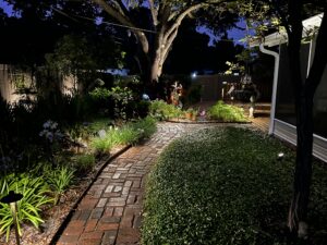 path lighting along a brick walkway with greenery