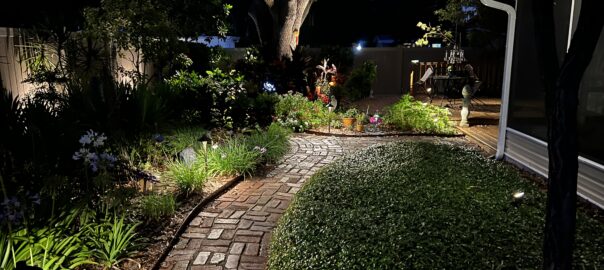 path lighting along a brick walkway with greenery