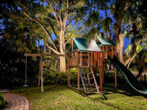 Well lit children's play house and landscaping