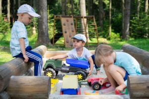 3 kids playing in sandbox