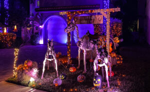 Ghost town halloween decor, front yard, orange and purple lighting 