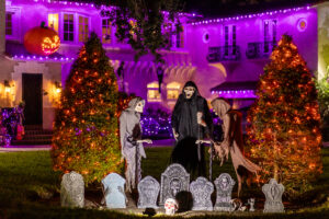 Halloween lights and decor Brightwaters Blvd with skeletons and graveyard scene