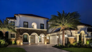 2 story home with stone facade gets outdoor lighting to elevate curb appeal