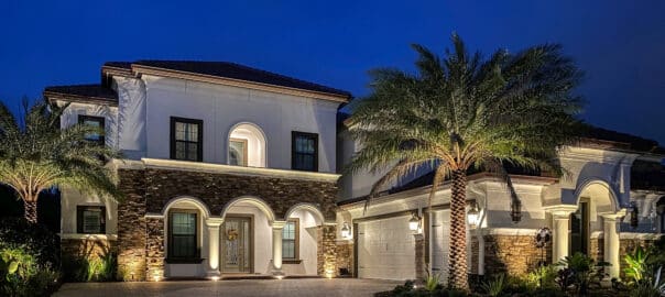 2 story home with stone facade gets outdoor lighting to elevate curb appeal